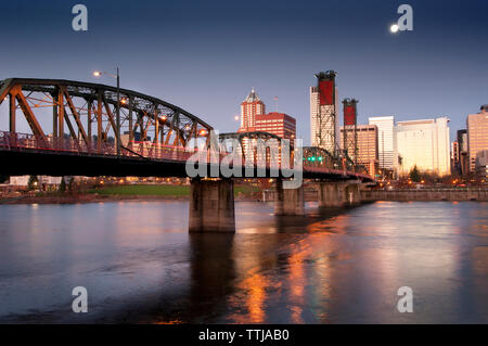 View of bridge over river against city Stock Photo