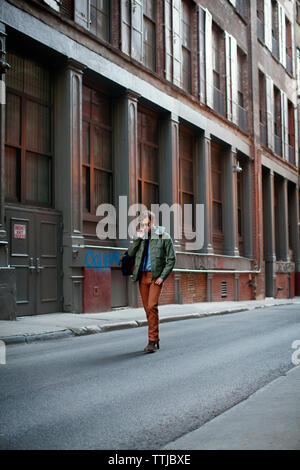 Man walking on city street Stock Photo