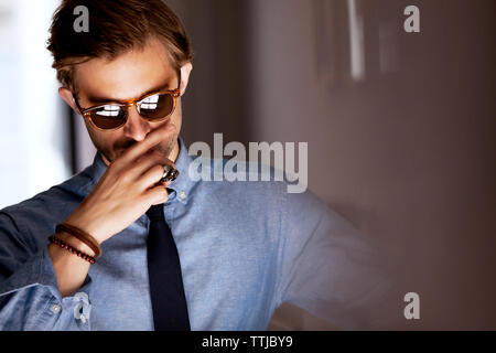 Man wearing sunglasses standing at home Stock Photo