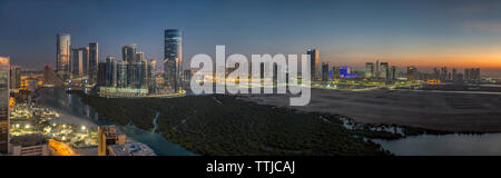 Sunset over City of Lights area of Reem Island in Abu Dhabi, UAE Stock Photo