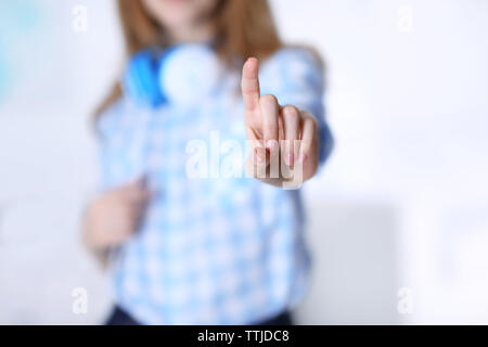 Female hand with pointing finger on blurred background Stock Photo