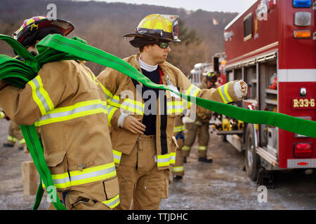 Firefighters working at field Stock Photo