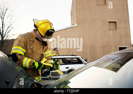 Firefighters rescuing by cutting car windshield Stock Photo