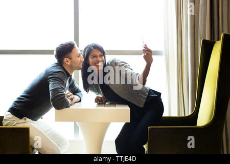 Colleagues taking selfie with tablet computer in office Stock Photo