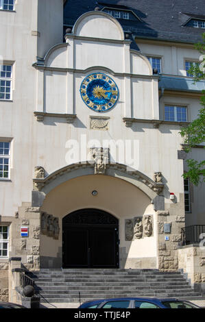 Facade with clock face at Schule am Rathaus in Berlin Lichtenberg Stock Photo