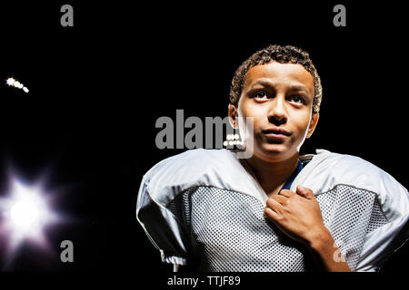 Player looking away while standing on field against sky Stock Photo