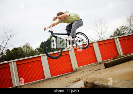 Man performing stunt against clear sky Stock Photo