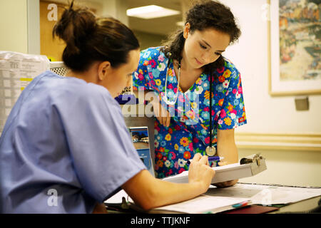 Doctors discussing while working in hospital Stock Photo