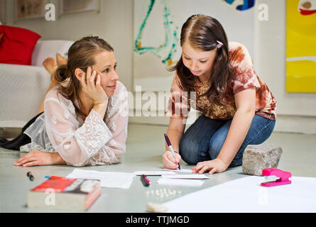 Woman looking daughter studying Stock Photo