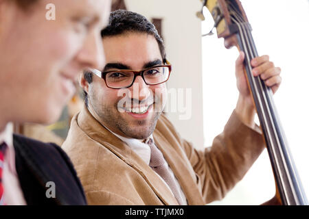 Man looking at friend while practicing in studio Stock Photo