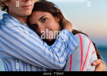 Midsection of man embracing girlfriend Stock Photo