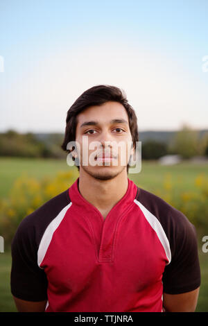 Portrait of rugby player standing on field Stock Photo