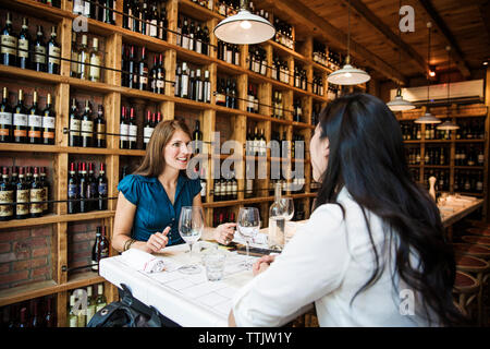 businesswomen talking while sitting in bar Stock Photo