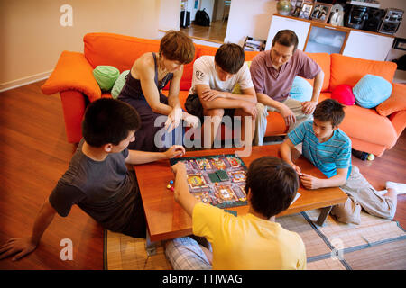 High angle view of family enjoying game in living room Stock Photo