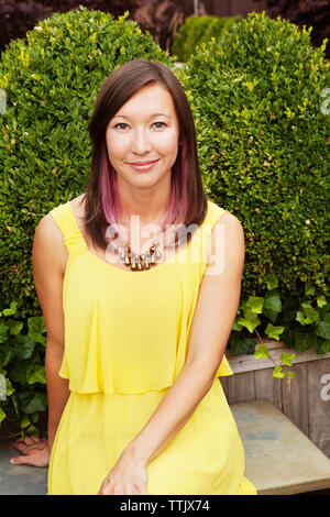Portrait of woman sitting on the terrace of a beach cafe Stock Photo ...