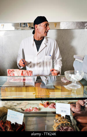 Butchers shop - butcher chopping up cow carcass on the street Stock ...