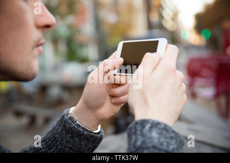 Cropped image of man using mobile phone Stock Photo