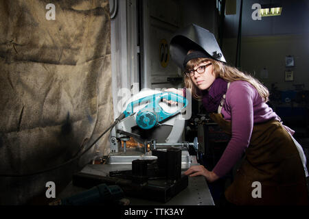 Portrait of worker operating circular saw in workshop Stock Photo