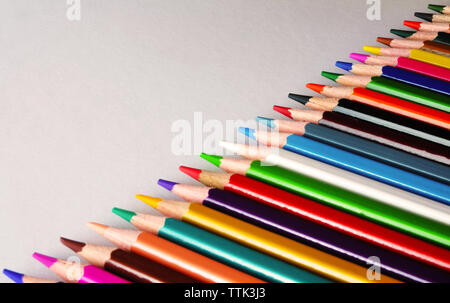 close-up of colored pencils lying on white paper Stock Photo