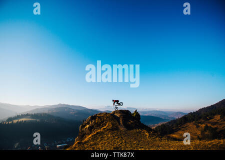 young men is riding on his bike on the rock, Slovakia Stock Photo