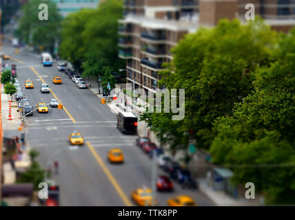Tilt-shift image of vehicles on city street Stock Photo