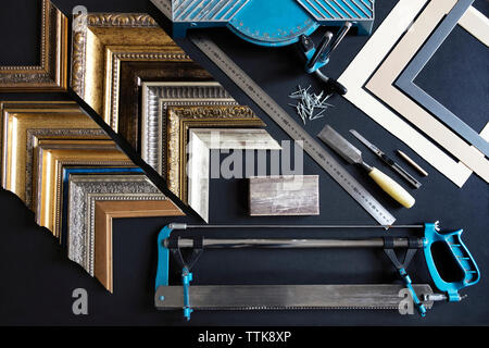 Overhead view of picture frame samples and work tools on table Stock Photo