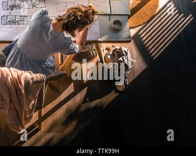 Young woman drawing architect plans from above Stock Photo
