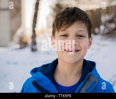 Portrait of smiling boy with braces wearing warm clothing during winter Stock Photo