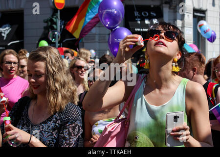 Woman blowing soap bubbles at Helsinki Pride Parade 2016 in Helsinki, Finland Stock Photo