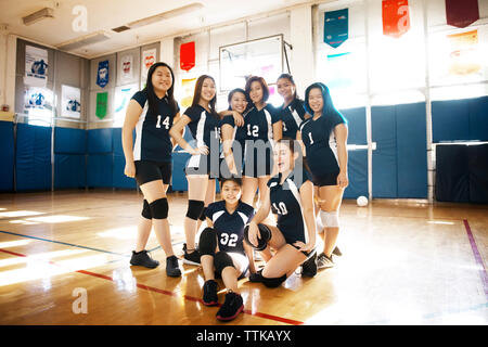 Portrait of happy female volleyball team at court Stock Photo