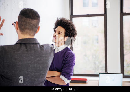 businessmen discussing over chart in creative office Stock Photo