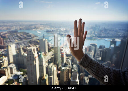 Cropped image of woman touching window glass Stock Photo