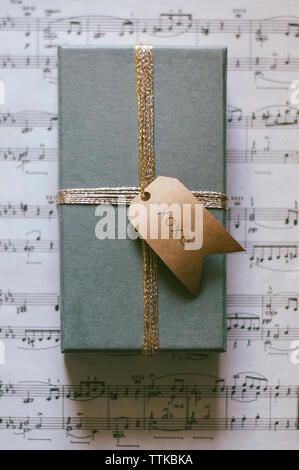 Overhead view of gift box on sheet music Stock Photo