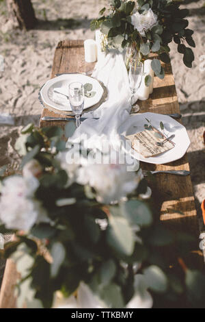 High angle view of place setting at beach during wedding ceremony