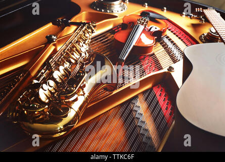 Musical instruments lying on piano, close up Stock Photo