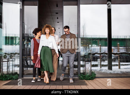 Happy business people leaving cafe Stock Photo