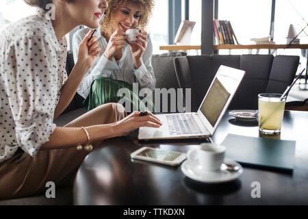 businesswomen working on laptop at restaurant Stock Photo