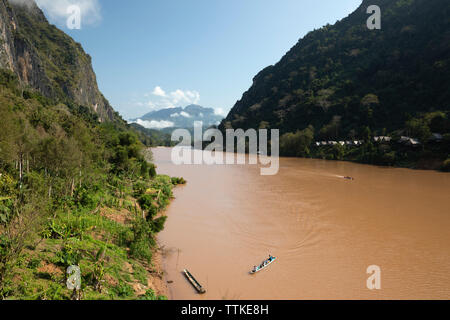 View looking north of the Nam Ou River at the village of Nong Khiaw in morning sunshine, Muang Ngoi District, Luang Prabang Province, Northern Laos, L Stock Photo