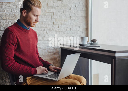 businessman using laptop in restaurant Stock Photo