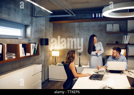 business people discussing at desk in office Stock Photo