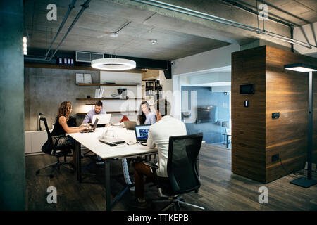 business people using laptops while working in office Stock Photo