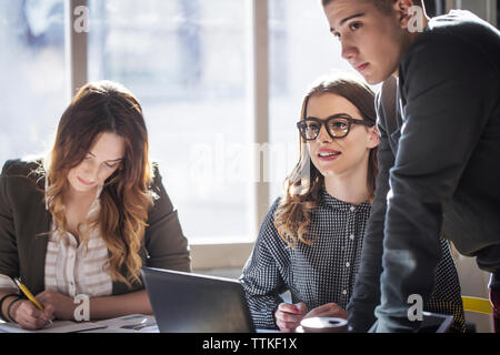 Friend at table in classroom Stock Photo