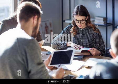 Students sitting at table in college Stock Photo