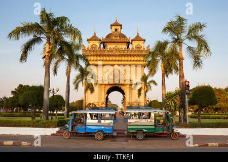 Tuk-tuks parked in front of the Patuxai Victory Monument (Vientiane Arc de Triomphe), Vientiane, Laos, Southeast Asia