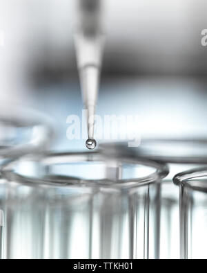 Close-up of sample being pipetted into test tube for analysis in laboratory Stock Photo