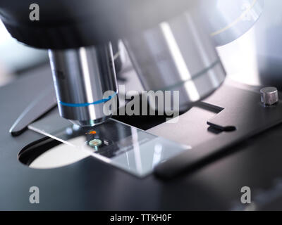 Close-up of slide on microscope in laboratory Stock Photo