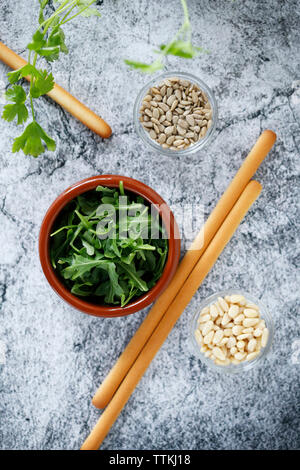 Overhead view of breadsticks with parsley and seeds on table Stock Photo