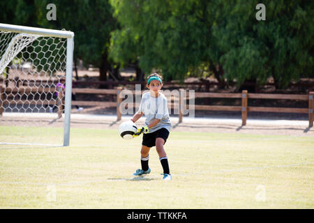 Girl practicing soccer in playground Stock Photo