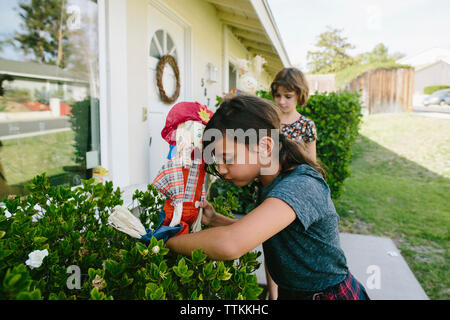 Sisters playing with toy in backyard Stock Photo