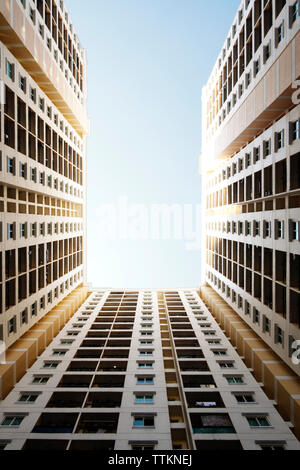 Directly below shot of residential buildings against clear sky Stock Photo